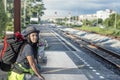 Young man with backpack waiting for next the train station. Royalty Free Stock Photo