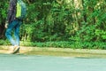 Young man with backpack walking in the park