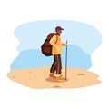 young man with backpack walking sand