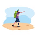 young man with backpack walking sand