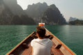 Backpacker traveling by longtail boat, in Cheow Lan Lake, Khao Sok, Thailand Royalty Free Stock Photo