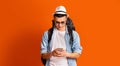 Young man backpacker using mobile phone app for travelers Royalty Free Stock Photo