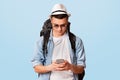 Young man backpacker using mobile phone app for travelers Royalty Free Stock Photo