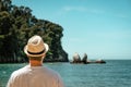 Young man backwards looking at Split Apple Rock, Abel Tasman National Park, New Zealand Royalty Free Stock Photo