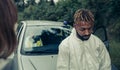 Young man with bacteriological protective suit with worried face