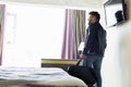 Young man with bag in hotel room Royalty Free Stock Photo