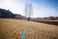 Young man balancing and jumping on slackline. Man walking, jumping and balancing on rope in park Sports a tightrope or slackline Royalty Free Stock Photo