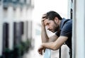 Young man at balcony in depression suffering emotional crisis and grief Royalty Free Stock Photo