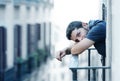 Young man at balcony in depression suffering emotional crisis and grief
