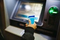 Young man at a bank cashier on street