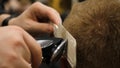 Young Man in Barber Shop Hair Care Service Concept. Man`s hands doing a haircut for man at barber shop, close up Royalty Free Stock Photo