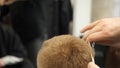 Young Man in Barber Shop Hair Care Service Concept. Man`s hands doing a haircut for man at barber shop, close up Royalty Free Stock Photo