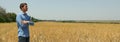 Young man in barley field Agriculture business. Farming