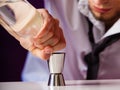 Young man bartender preparing alcohol drink