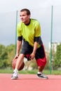 Young man on basketball court dribbling with ball