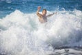 Young man bathing in storming sea.