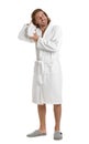 Young man in bathrobe drying hair with towel on background Royalty Free Stock Photo