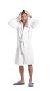 Young man in bathrobe drying hair with towel on background Royalty Free Stock Photo