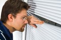 Young man in bathrobe looking out of the window Royalty Free Stock Photo