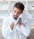 Young man in a bathrobe after shower drying hair with a towel Royalty Free Stock Photo