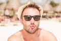 Young man on the beach sending you a kiss. Royalty Free Stock Photo