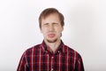 Young man with beard in checkered red shirt dabbles