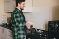 Young man with beard cooking dinner at the kitchen. Royalty Free Stock Photo