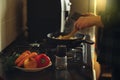 Young man with beard cooking dinner and using his smart phone at the kitchen. Royalty Free Stock Photo