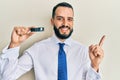 Young man with beard holding ssd memory smiling happy pointing with hand and finger to the side Royalty Free Stock Photo