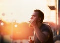 Young man with a beard makes the bubble with the steam inside, creating soft background of the urban landscape Royalty Free Stock Photo