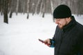 Young man with a beard outdoors in the snow in the winter Royalty Free Stock Photo