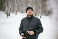 Young man with a beard outdoors in the snow in the winter Royalty Free Stock Photo