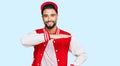 Young man with beard wearing baseball uniform gesturing with hands showing big and large size sign, measure symbol Royalty Free Stock Photo