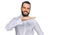 Young man with beard wearing business shirt gesturing with hands showing big and large size sign, measure symbol Royalty Free Stock Photo