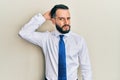 Young man with beard wearing business tie confuse and wonder about question Royalty Free Stock Photo