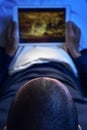 Young man in bed watching a movie or a series in his tablet Royalty Free Stock Photo