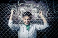 A young man behind bars close Royalty Free Stock Photo