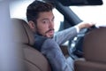 Successful man sitting behind the wheel of a prestigious car Royalty Free Stock Photo