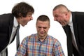 Young man being yelled at by two senior male manager on white