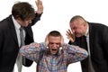 Young man being yelled at by two senior male manager on white