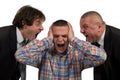 Young man being yelled at by two senior male manager on white