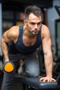 young man on bench lifting weights in gym Royalty Free Stock Photo