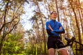 Young man bicyclist riding a road bike in spring forest. Man having rest Royalty Free Stock Photo