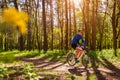 Young man bicyclist riding a road bike in spring forest Royalty Free Stock Photo
