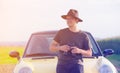 Young man with binoculars standing near a car Royalty Free Stock Photo