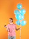 Young man with birthday muffin and air balloons Royalty Free Stock Photo