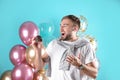 Young man with birthday muffin and air balloons Royalty Free Stock Photo