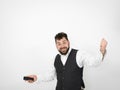 Young man with black beard is posing and looking at his smartphone in front of white background with different emotions Royalty Free Stock Photo