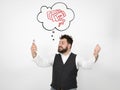 Young man with black beard is posing and looking at his smartphone in front of white background with different emotions Royalty Free Stock Photo