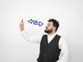 Young man with black beard is posing and looking at his smartphone in front of white background with different emotions Royalty Free Stock Photo